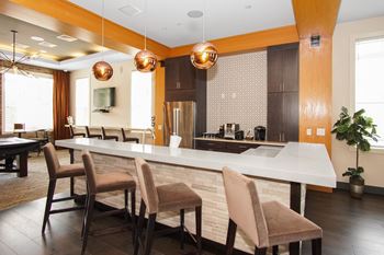 A kitchen with an island and a dining table